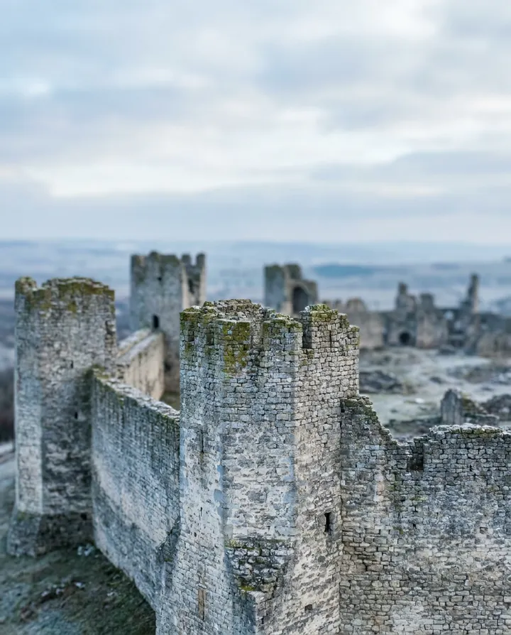 The stone walls and towers of an old fortress, a frame from a history documentary